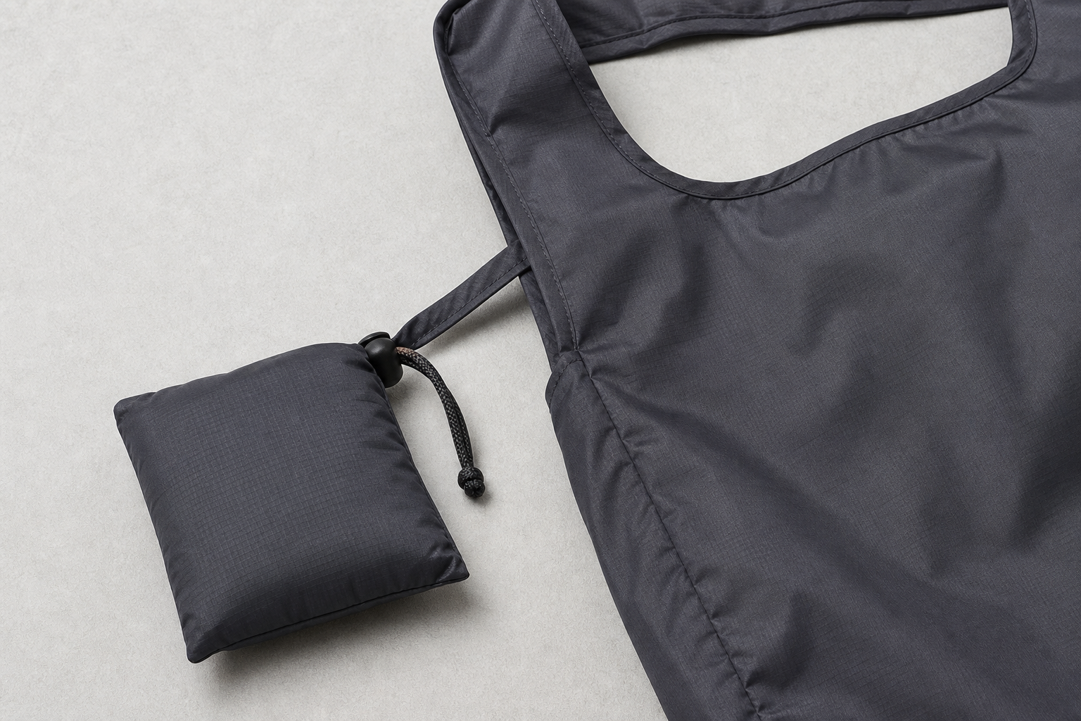Foldable tote packed into its attached pouch