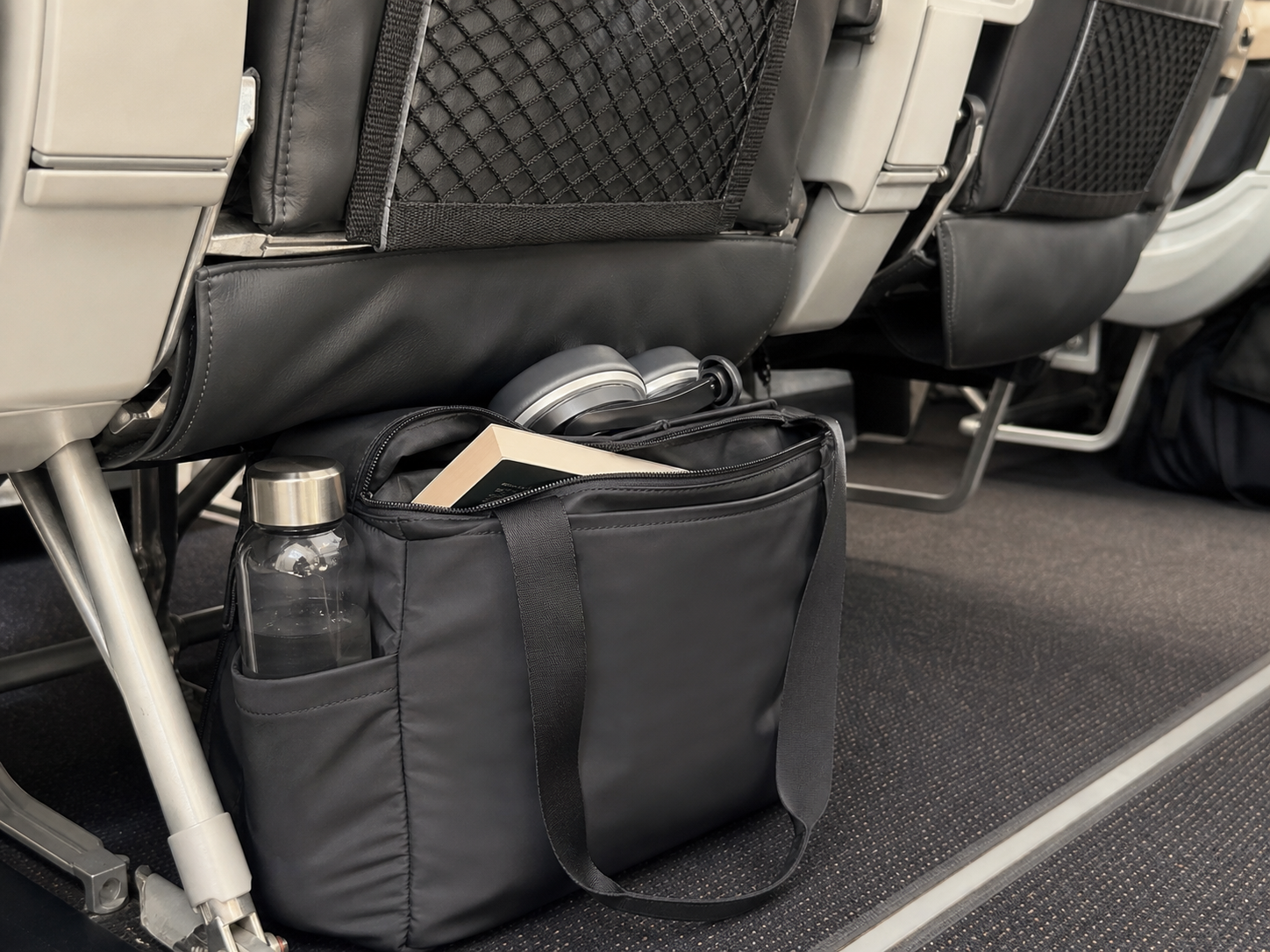SeatPocket Flight Tote placed neatly under an airplane seat